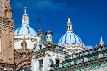 Fototapeta na wymiar Domes and towers of the beautiful and old Cathedral of Cuenca, Ecuador, South America, on a sunny morning.