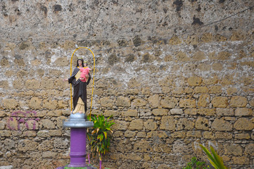 Religious image standing in front of the wall