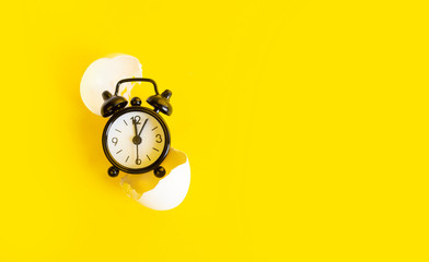 Black clock on a yellow background