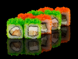 Uramaki Sushi roll with eel, cheese, omelet and green and orange tobiko caviar isolated on black...