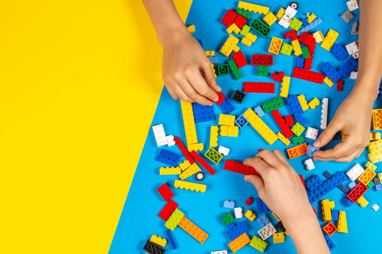 Vilnius, Lithuania - February 23, 2019. Children hands play with colorful lego blocks on the table