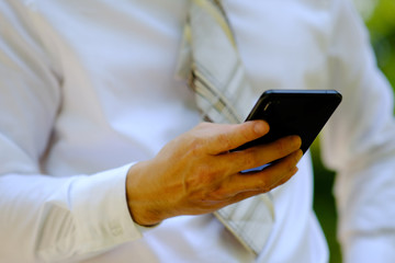 close up businessman using a smartphone and space for text