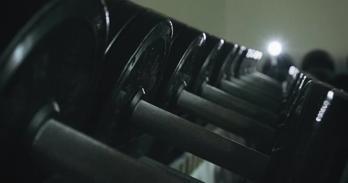 Dumbbells row in modern sport club gym. Close up of sport equipment