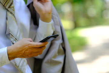 close up businessman using a smartphone and space for text