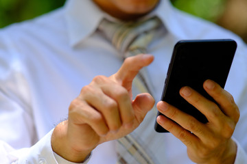 close up businessman using a smartphone and space for text