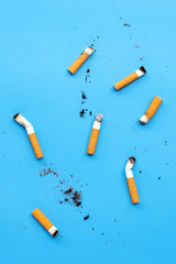 Cigarette butts on blue background.