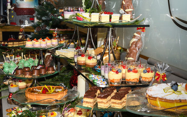 Various desserts in candy bar food buffet during hotel brunch, catering, cake pops, mousse, tarts