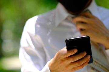 close up businessman using a smartphone and space for text
