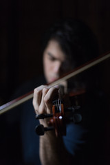 A boy playing violin in quarantine