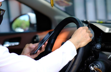 businessman using his phone while traveling drive in a car