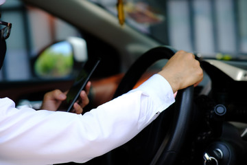 businessman using his phone while traveling drive in a car