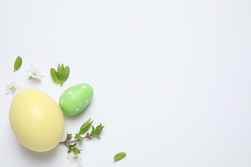 Flat lay composition with Easter eggs on white background. Space for text