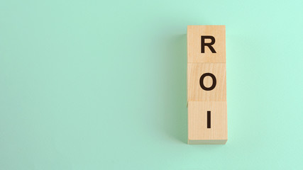 roi return on investment acronym on wooden blocks business concept