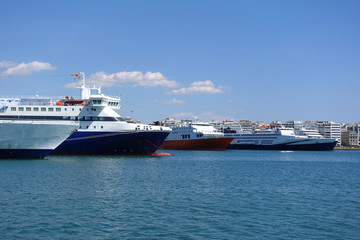 Photo of anchored passenger ferries in busy port of Piraeus on a spring morning, Attica, Greece