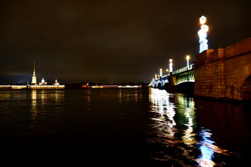 Fototapeta na wymiar olorful lighting of the bridge on the background of the tower