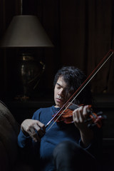 A boy playing violin in quarantine
