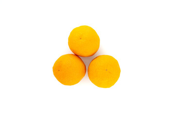 Three oranges isolated on white background. Creative healthy food concept. Top view.