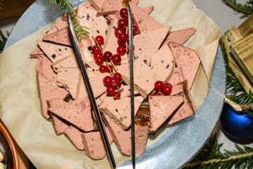 Duck foie gras slices with cranberry. Food selection during Sunday brunch buffet in hotel.