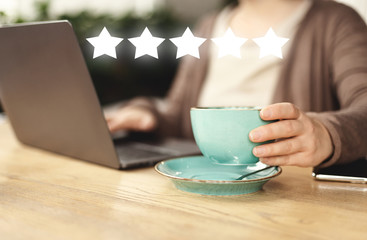 University student working with laptop and coffee in cafe