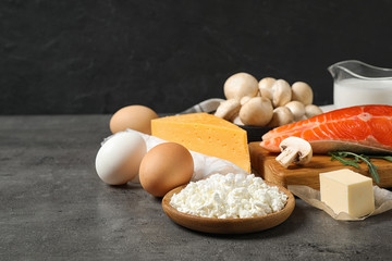 Fresh products rich in vitamin D on grey table