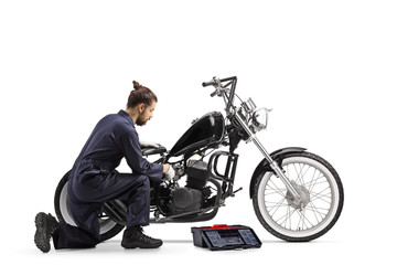 Obraz na płótnie Canvas Motorcycle mechanic with a tool box repairing a chopper motorbike