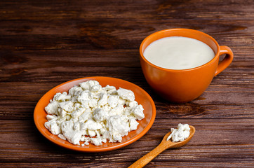 Homemade dairy products - kefir, cottage cheese on a wooden background, copy space, flat lay.
