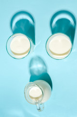 Homemade fermented drink - kefir on a blue background with copy space.