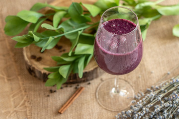 currant smoothie, purple, on a beige background