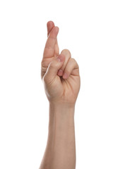 Man with crossed fingers against white background, closeup of hand