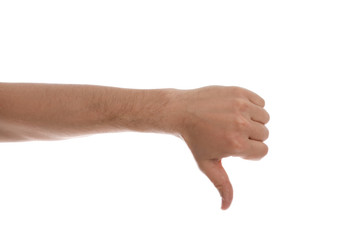 Man showing thumb down gesture against white background, closeup of hand