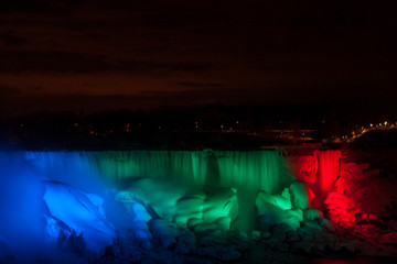 Night Niagara falls. Colorful lights USA side