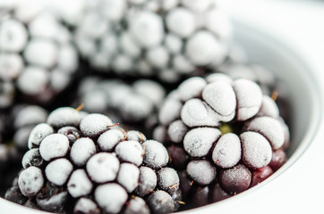 Frozen blackberries on a white background. Close up, season concept, season.