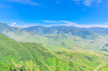 Scenic mountain landscape with layer of peaks at the North Vietnam against sunny cloud blue sky
