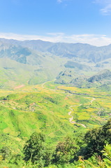 Aerial view of mountain layers surrounds a remote town in Mu Can Chai, Yen Bai, Vietnam
