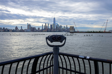 Urban New York City Skyline background. Looking across hudson river to NYC. Urban city skyline background. Isolated binoculars.  - 348354174
