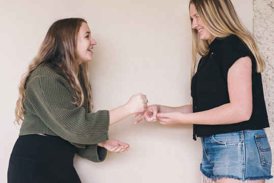two friends playing rock paper scissors