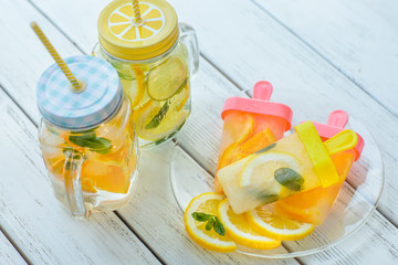 Overhead view of fruit popsicles and lemonade