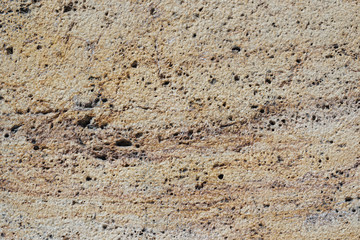 Rough surface of an eroded travertine marble stone