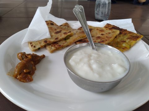 Tasty potato Parathas with curd and tea, Indian Breakfast
