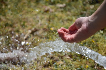 water flowing in the hands