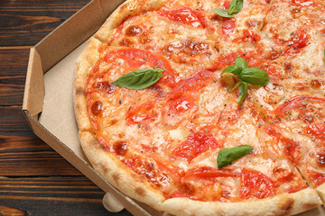 Delicious pizza Margherita on wooden table, closeup view