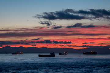 Tanker and Freighter Ships Wait in Burrard Inlet Vancouver, British Columbia to load and unload at the Port of Vancouver