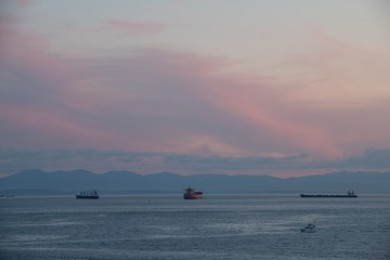 Tanker and Freighter Ships Wait in Burrard Inlet Vancouver, British Columbia to load and unload at the Port of Vancouver