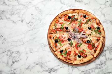 Tasty pizza with seafood on white marble table, top view. Space for text