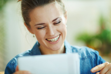 Fototapeta premium female with tablet PC study online in modern house in sunny day