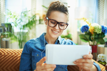 happy woman with white headphones and tablet PC study online