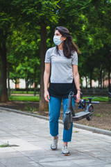 Image of a woman on an electric scooter with mask 