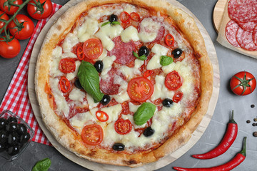 Delicious pizza Diablo on grey table, flat lay