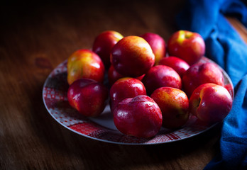 Fototapeta na wymiar A group of colorful nectarine fruits or peach on a plate