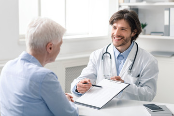 Friendly geriatrician explaining prescription for senior patient
